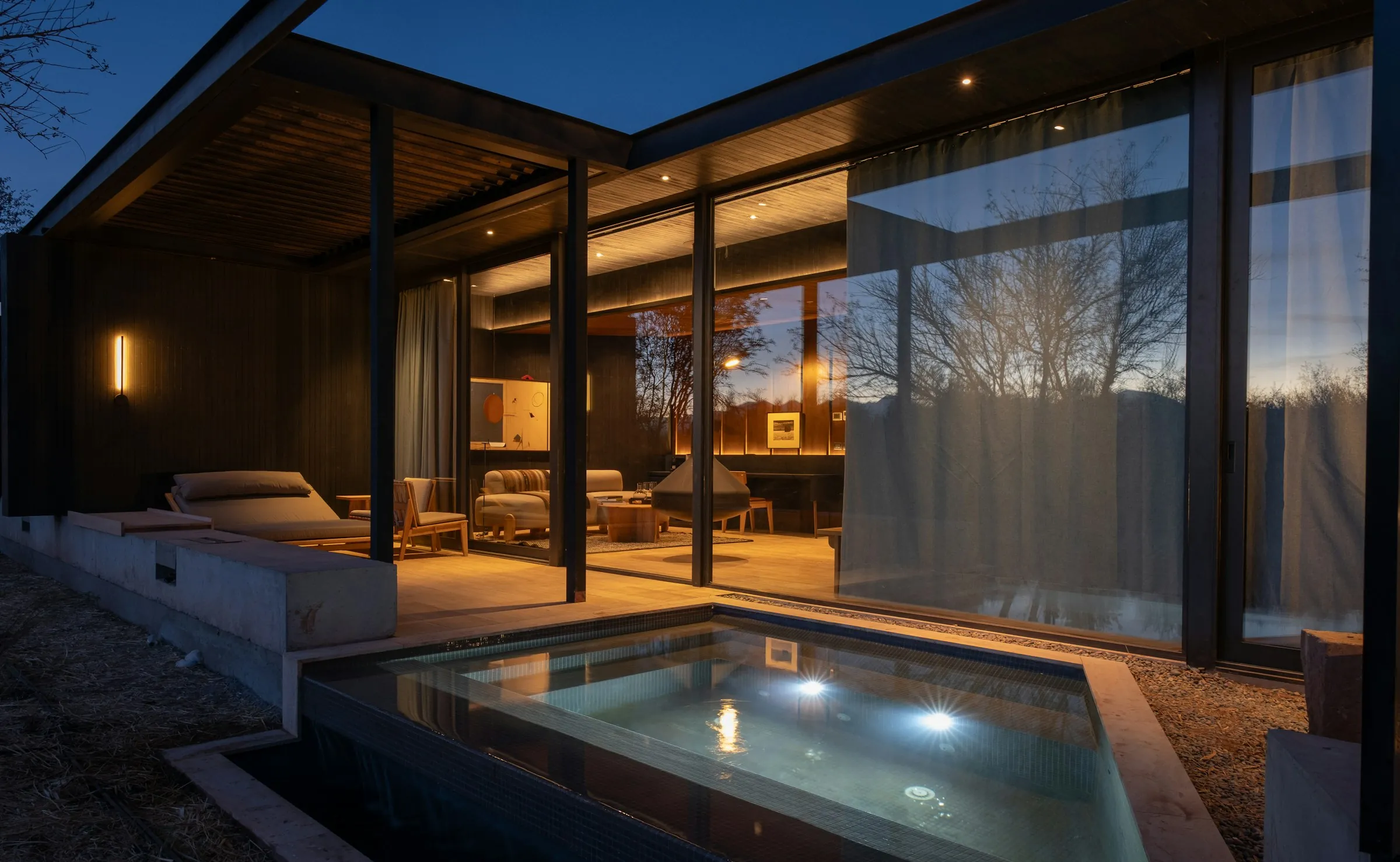 Modern home with pool at dusk